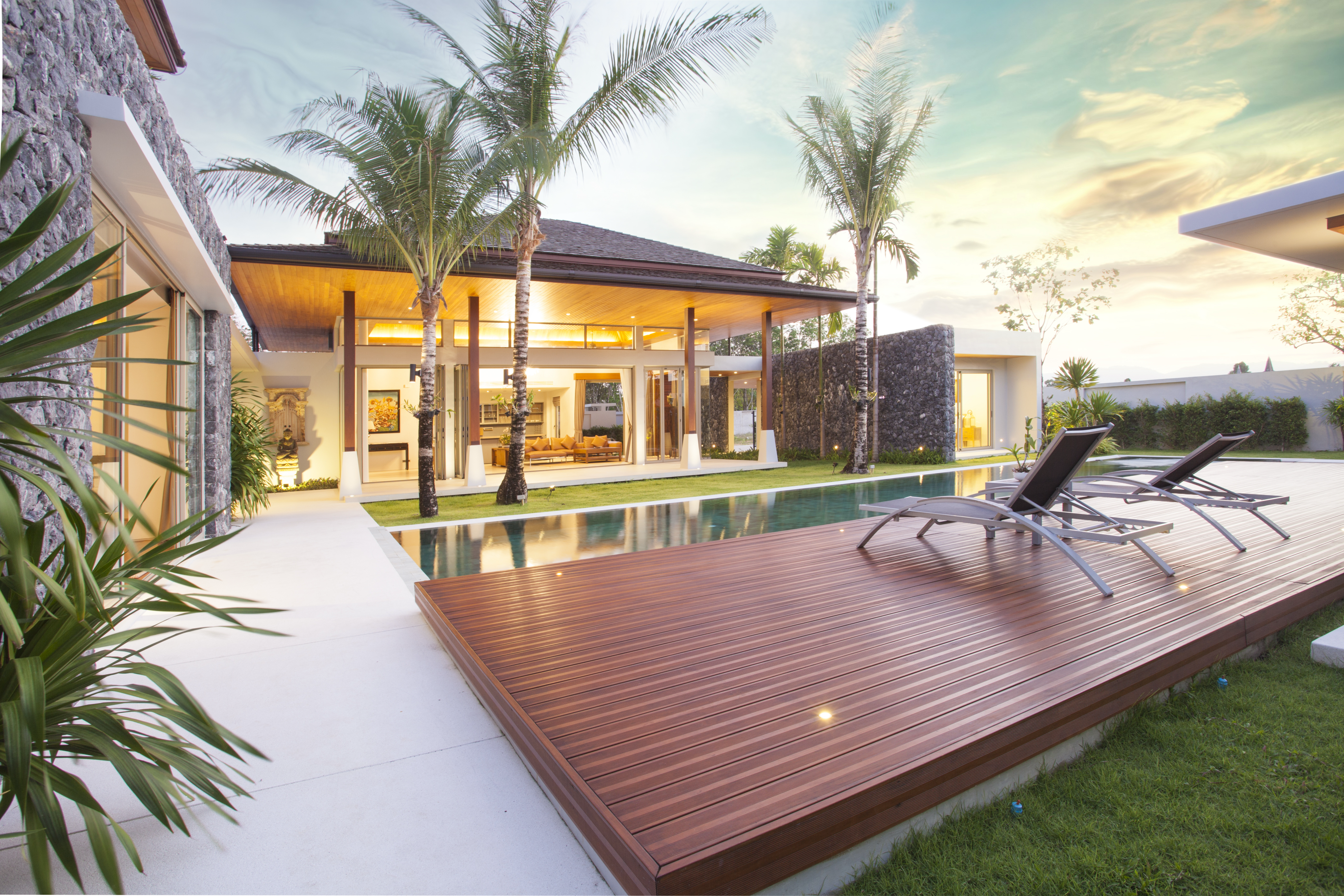 A stunning backyard pool area featuring a beautifully crafted paved deck, expertly designed by deck builders in Hollywood Hills. This outdoor space highlights a custom deck installation, showcasing the skill and precision of professionals in outdoor deck installation and deck building.