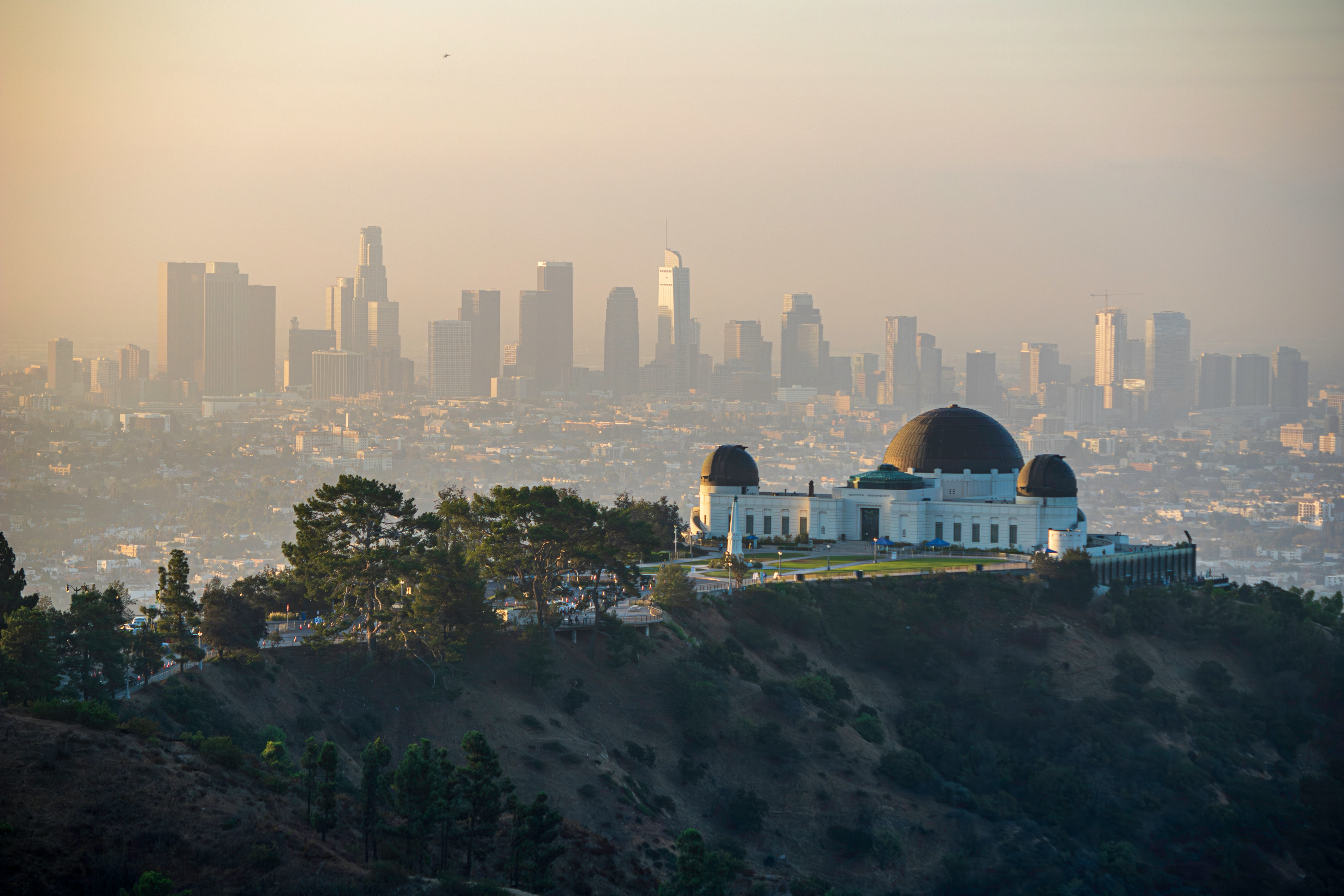 Iconic Griffith Observatory on top of a mountain in Hollywood Hills, symbolizing the craftsmanship of local concrete contractors. Renowned for their custom patio installation in Hollywood Hills, these experts also excel in driveway construction, patio construction, and block wall installation, remodeling backyards.