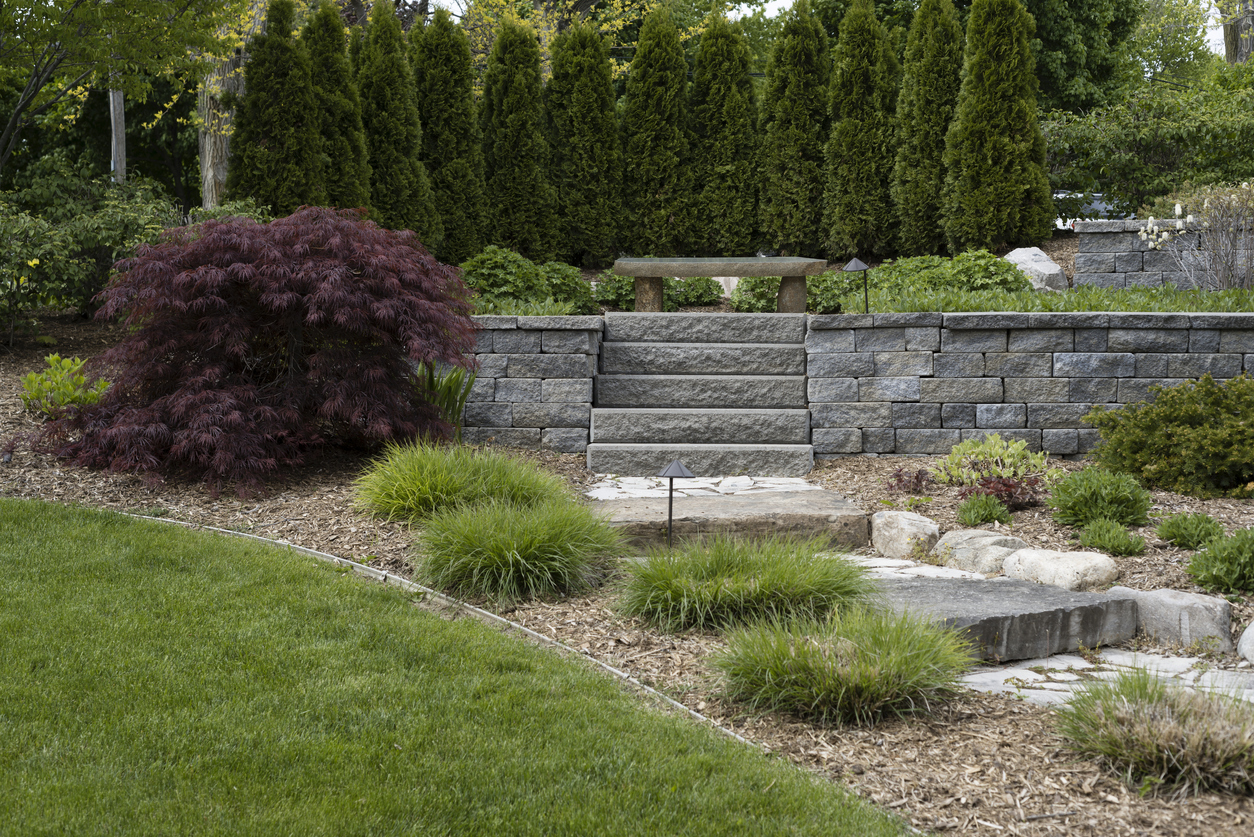 A beautifully constructed charcoal garden wall showcasing expert stone garden wall construction and block wall construction techniques.