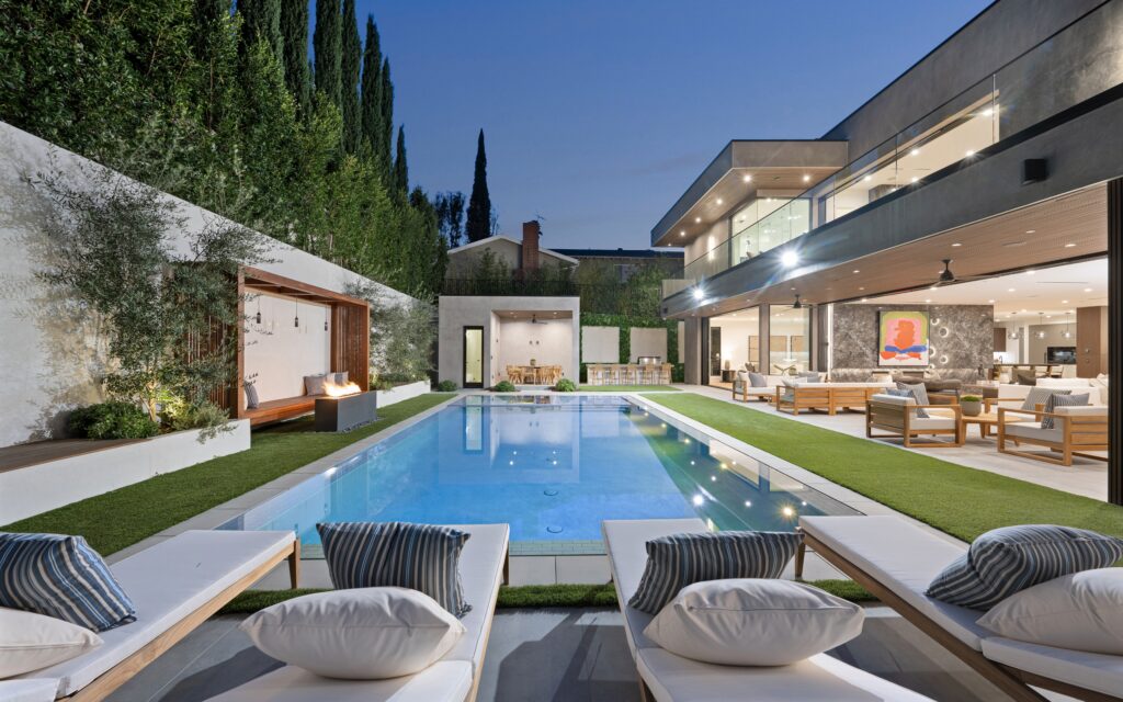 Image showcasing a modern backyard with a pool and an elegant patio.