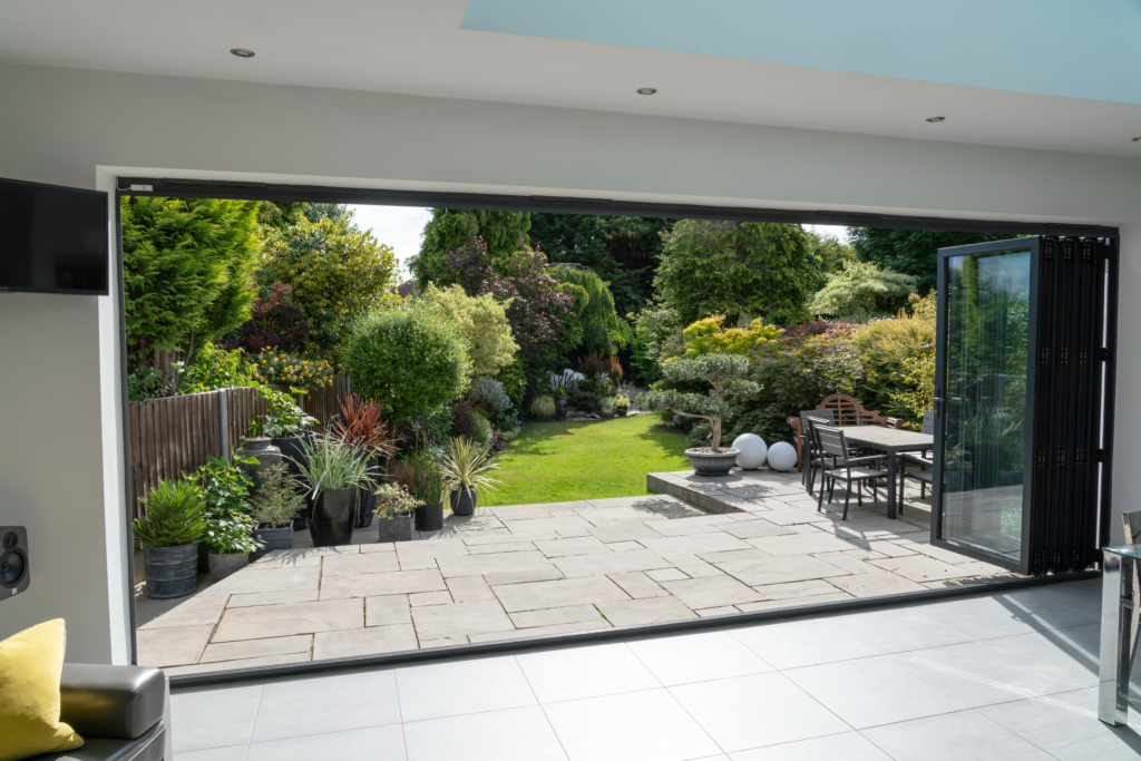 Image showcasing a concrete patio from the inside of a house.