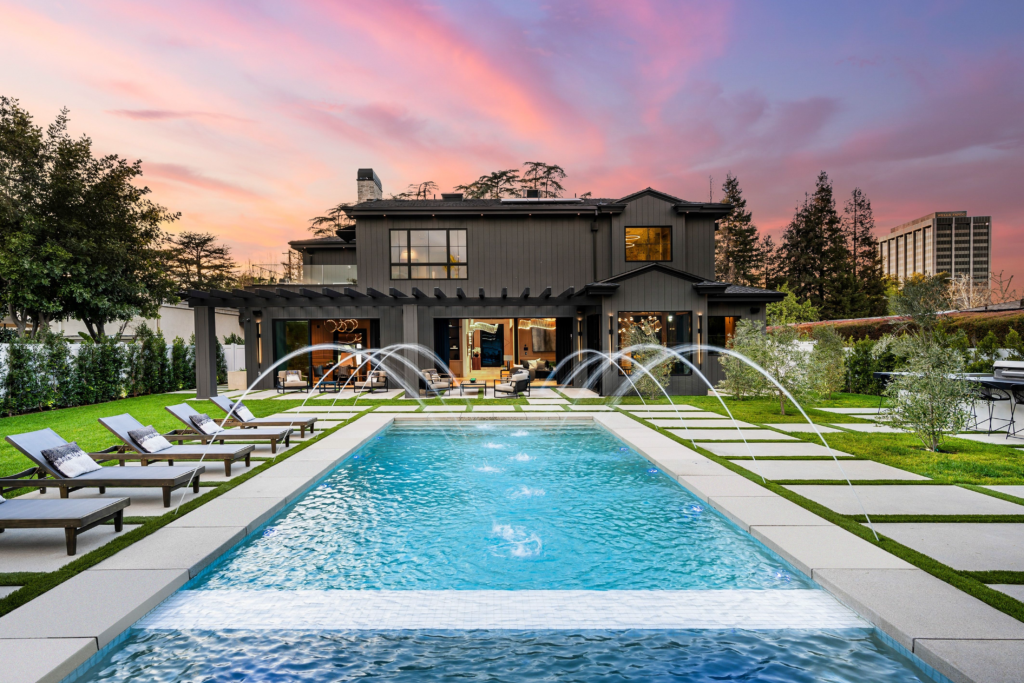 Image showcasing a breathtaking backyard with a pool and an indoor-outdoor patio.