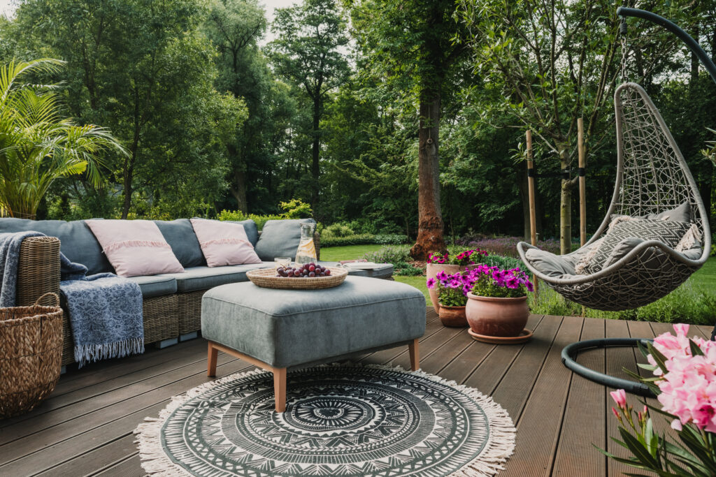 Image showcasing comfortable outdoor furniture in a backyard. 